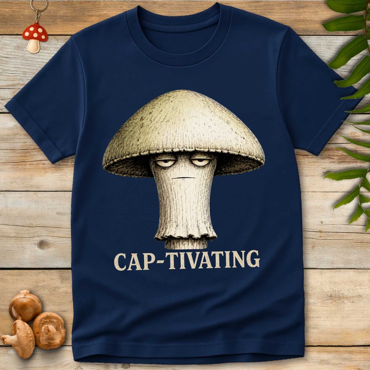 Vintage-style illustration of a bored-looking mushroom with droopy eyes above the words "CAP-TIVATING" on a navy background.