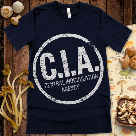 Distressed Navy T-shirt graphic reading “C.I.A. Central Inoculation Agency” in bold circular stamp-style design