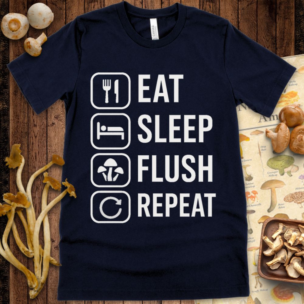 Navy t-shirt with white icons and text reading “Eat, Sleep, Flush, Repeat” showing utensils, bed, mushrooms, and a repeat arrow.