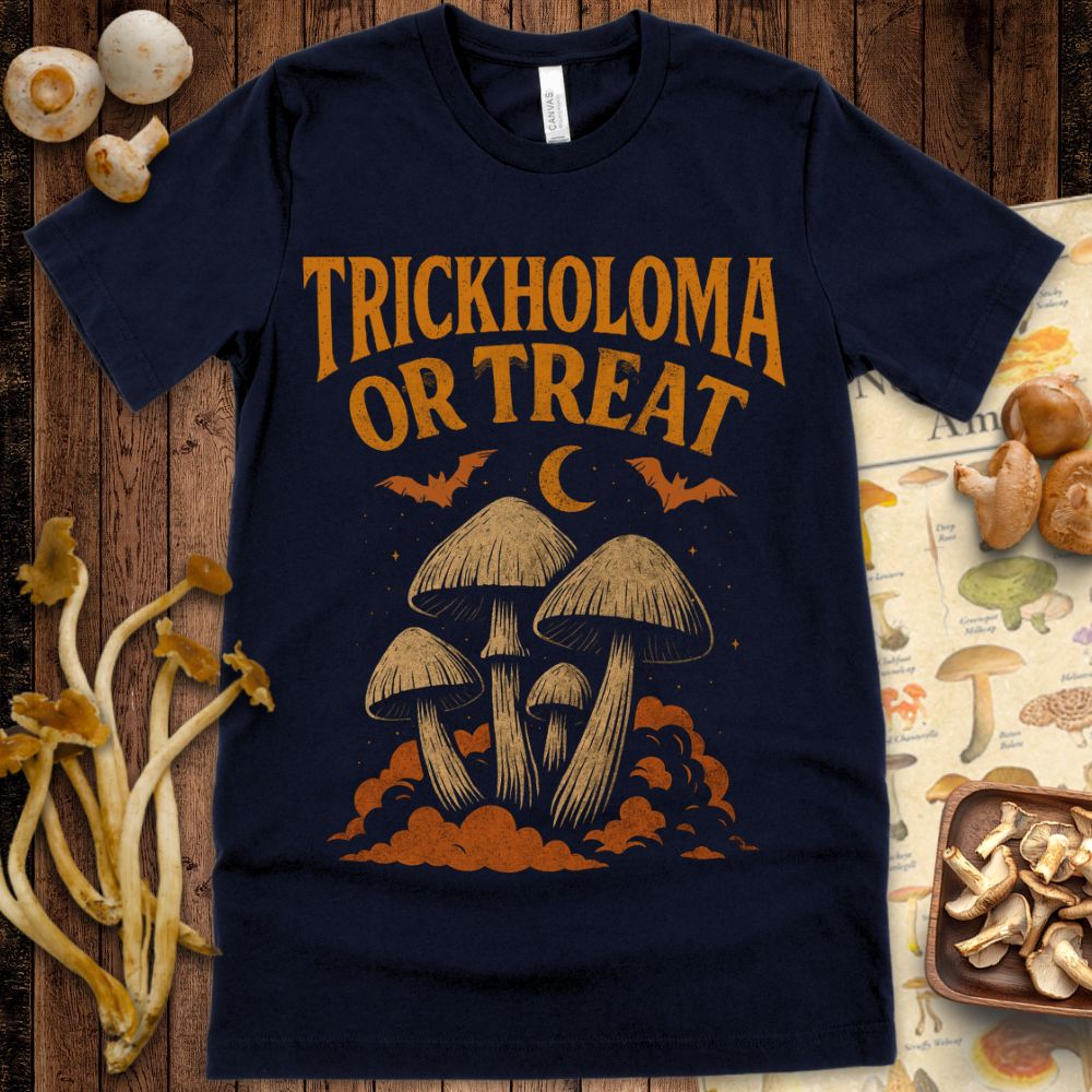 Retro-style Halloween tee design with the phrase "Trickholoma or Treat" above a cluster of mushrooms, bats, a crescent moon, and clouds in distressed orange ink on black.