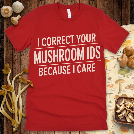 Modern graphic t-shirt with bold cream text reading “I Correct Your Mushroom IDs Because I Care” with underlined emphasis on a black background