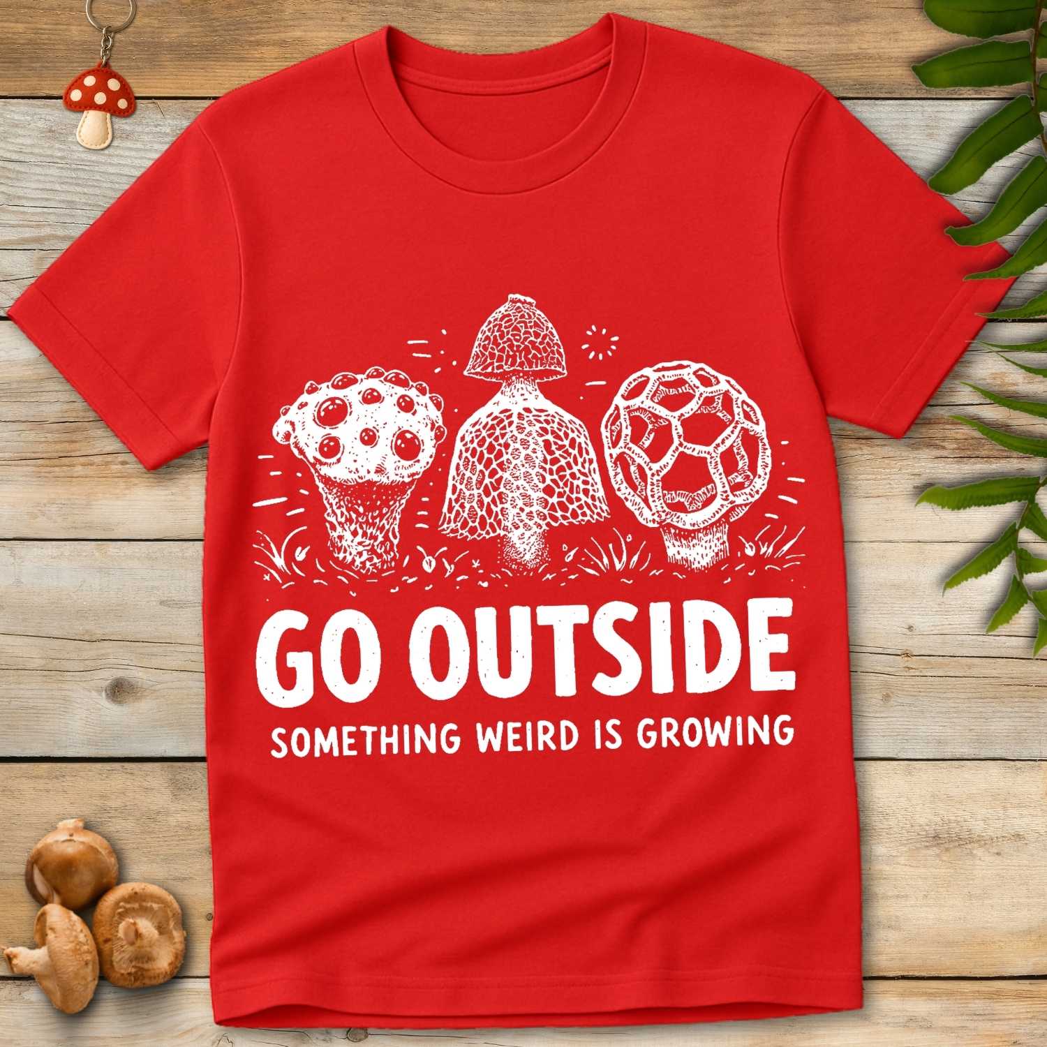 Vintage style illustration of three strange mushrooms with the phrase “Go Outside Something Weird Is Growing”.