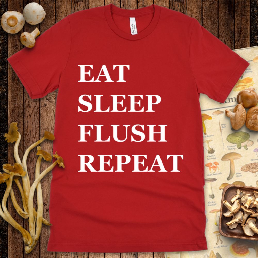 Red t-shirt design with bold white text reading “Eat, Sleep, Flush, Repeat” in all caps.